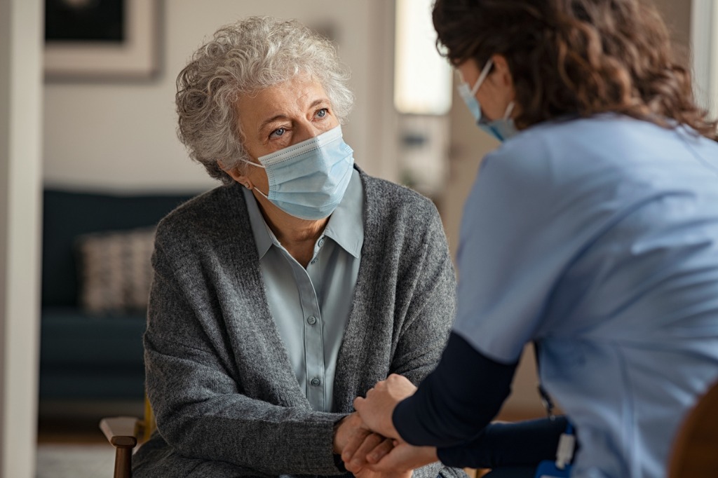 female doctor consoling patient with mask